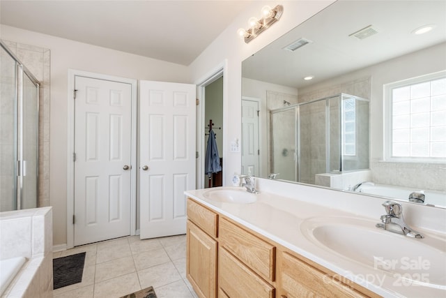 full bath featuring a sink, tile patterned floors, a stall shower, and visible vents