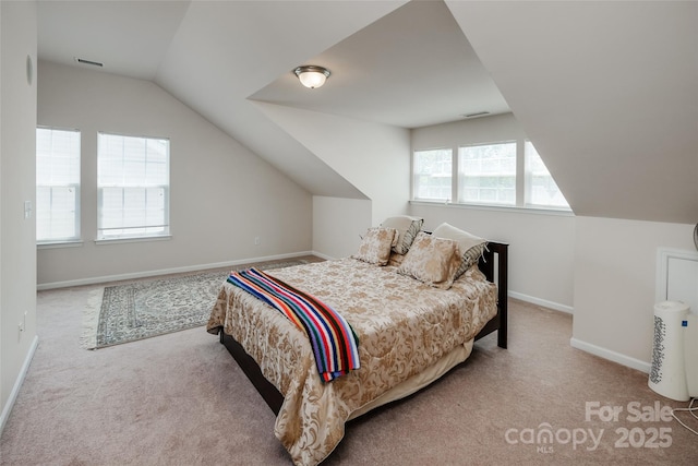 carpeted bedroom featuring baseboards, visible vents, and lofted ceiling