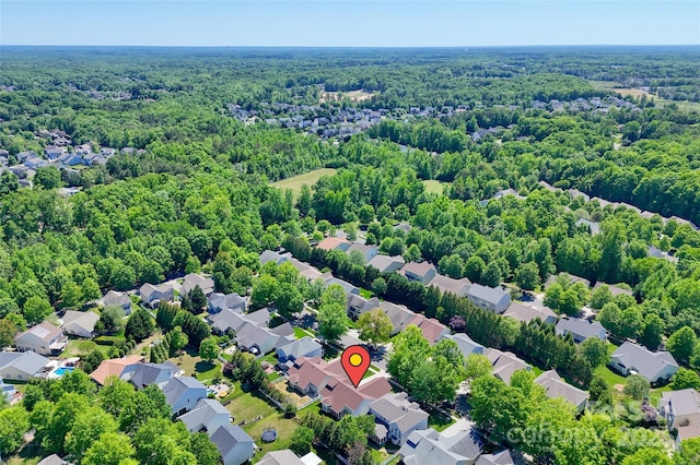 birds eye view of property with a residential view and a view of trees