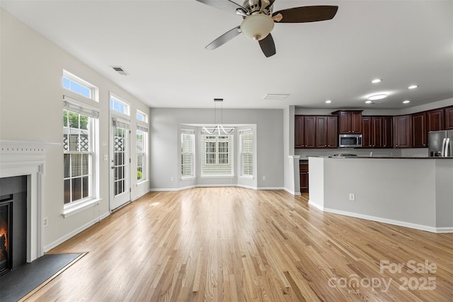 2151 Belle Vernon Ave, Charlotte, NC 28210 - unfurnished living room with a glass covered fireplace, plenty of natural light, light wood-style flooring, and recessed lighting