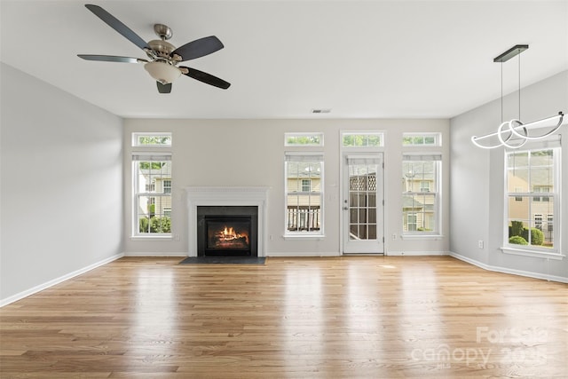 2151 Belle Vernon Ave, Charlotte, NC 28210 - unfurnished living room with wood finished floors, a fireplace with flush hearth, and baseboards