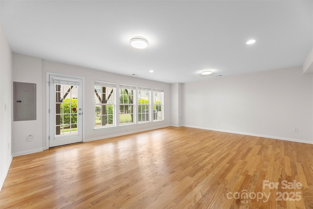 2151 Belle Vernon Ave, Charlotte, NC 28210 - spare room with electric panel, baseboards, light wood-style floors, and recessed lighting