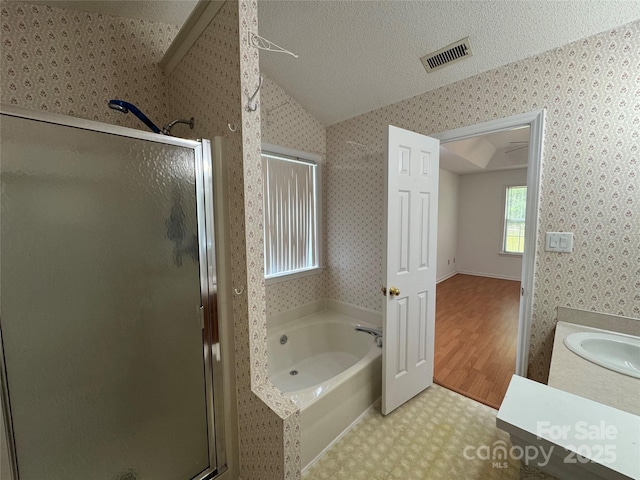 bathroom with visible vents, a stall shower, wallpapered walls, vaulted ceiling, and tile patterned floors