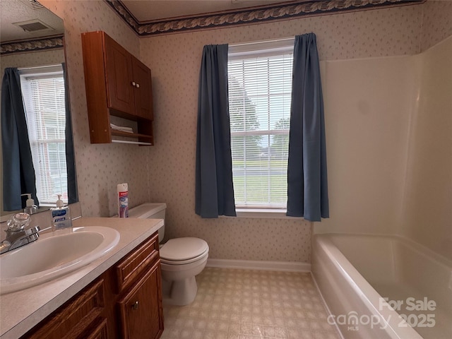 full bath with tile patterned floors, wallpapered walls, a healthy amount of sunlight, and vanity