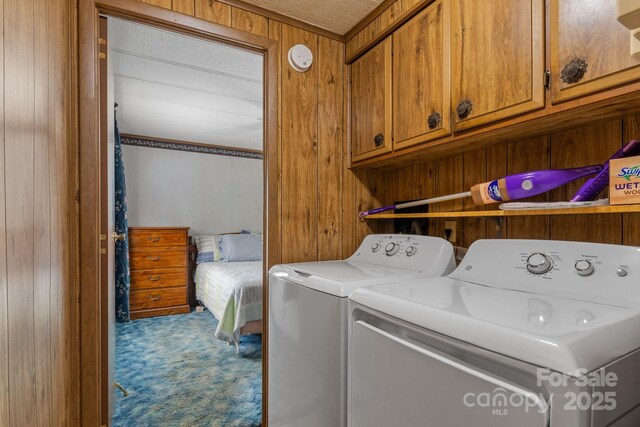 laundry room with carpet floors, cabinet space, and independent washer and dryer