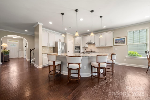 199 Blossom Ridge Dr, Mooresville, NC 28117 - kitchen featuring arched walkways, recessed lighting, stainless steel appliances, and tasteful backsplash