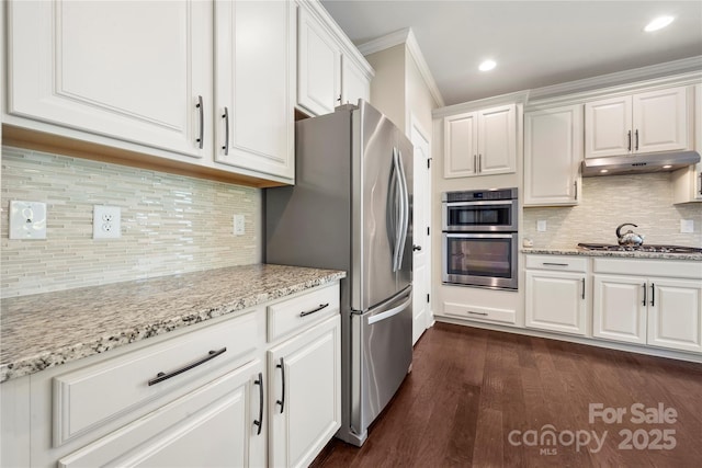 199 Blossom Ridge Dr, Mooresville, NC 28117 - kitchen featuring appliances with stainless steel finishes, white cabinets, dark wood-style floors, ornamental molding, and under cabinet range hood