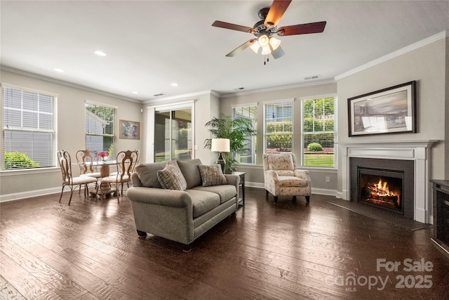 199 Blossom Ridge Dr, Mooresville, NC 28117 - living room featuring baseboards, ornamental molding, a lit fireplace, and visible vents