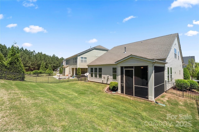 199 Blossom Ridge Dr, Mooresville, NC 28117 - rear view of house with a sunroom, a fenced backyard, roof with shingles, and a yard