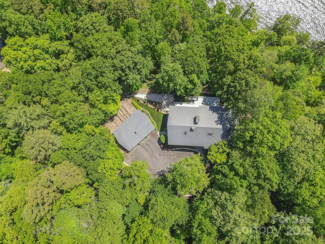 birds eye view of property with a view of trees