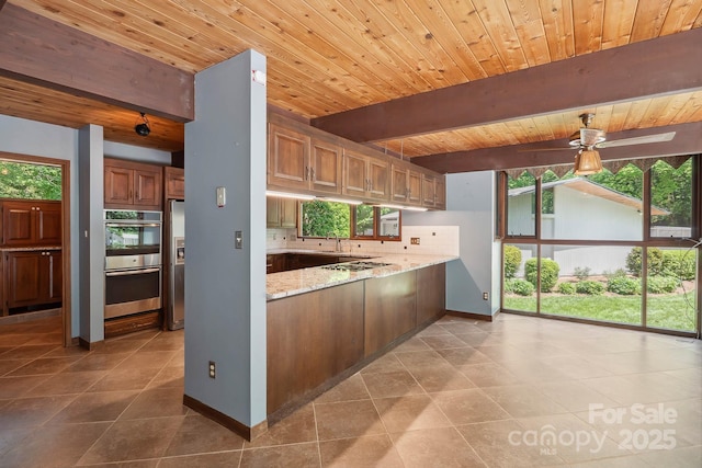 kitchen with plenty of natural light, wood ceiling, stovetop, and double oven