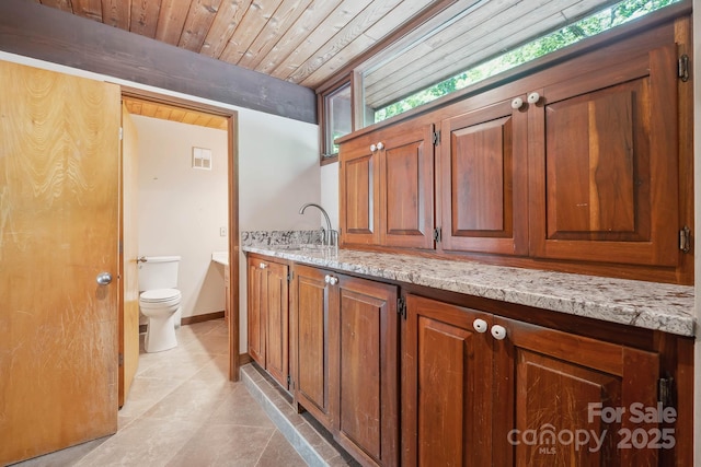 bathroom featuring vanity, tile patterned floors, toilet, and wooden ceiling