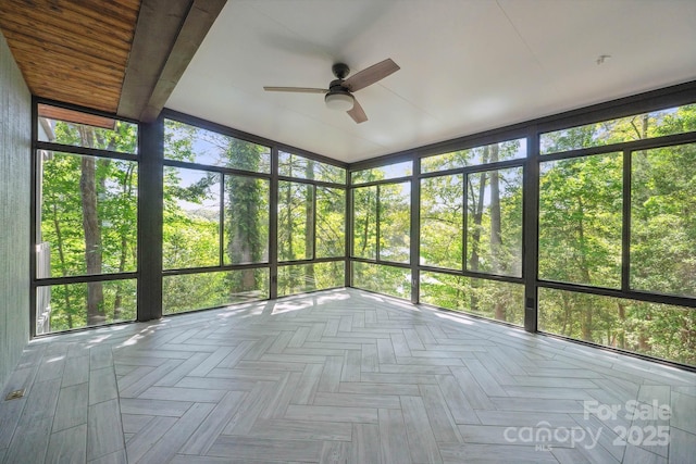 unfurnished sunroom with ceiling fan and a wealth of natural light