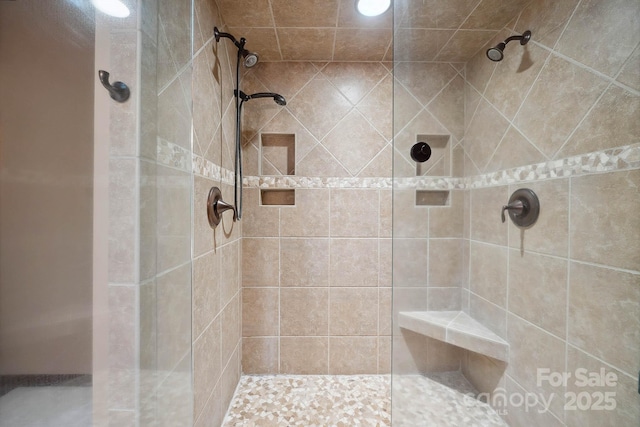 full bathroom featuring tiled shower