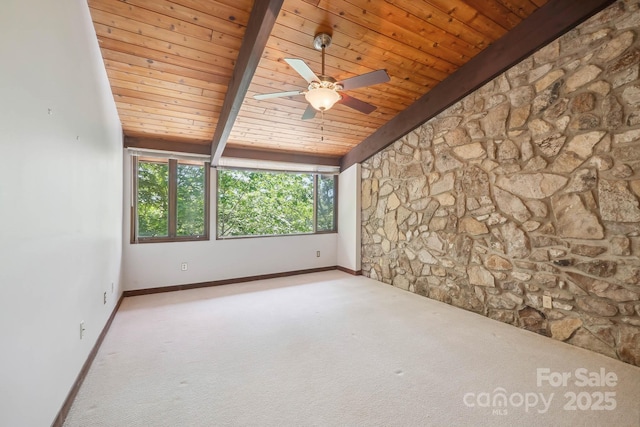 spare room with a ceiling fan, beamed ceiling, baseboards, wooden ceiling, and carpet flooring