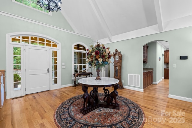 206 Stone Valley Way Unit 23, Hendersonville, NC 28792 - foyer entrance featuring arched walkways, high vaulted ceiling, beam ceiling, light wood-style flooring, and baseboards