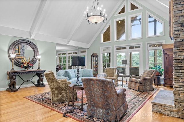206 Stone Valley Way Unit 23, Hendersonville, NC 28792 - living room featuring high vaulted ceiling, wood finished floors, a chandelier, beamed ceiling, and baseboards
