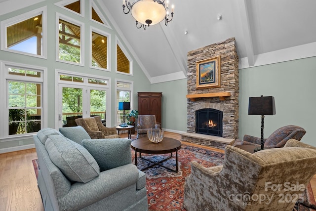 206 Stone Valley Way Unit 23, Hendersonville, NC 28792 - living area with high vaulted ceiling, a stone fireplace, wood finished floors, beam ceiling, and healthy amount of natural light