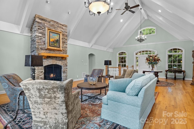 206 Stone Valley Way Unit 23, Hendersonville, NC 28792 - living room featuring beam ceiling, a stone fireplace, a ceiling fan, wood finished floors, and high vaulted ceiling