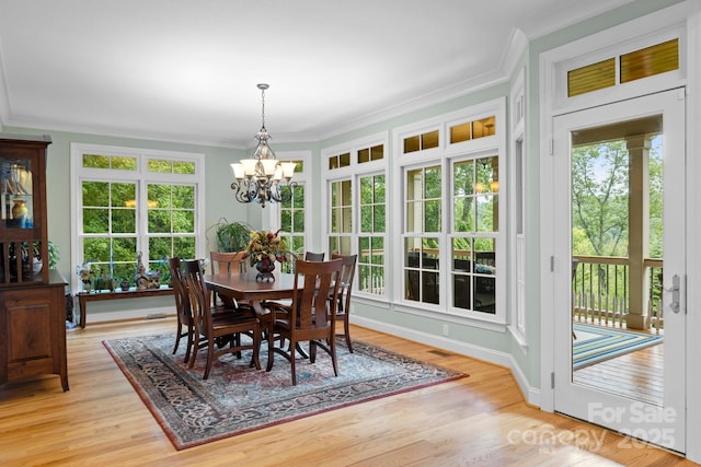 206 Stone Valley Way Unit 23, Hendersonville, NC 28792 - dining space featuring a chandelier, ornamental molding, and light wood-style flooring