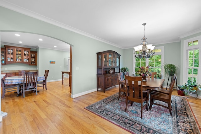 206 Stone Valley Way Unit 23, Hendersonville, NC 28792 - dining room with a chandelier, ornamental molding, light wood-style flooring, arched walkways, and baseboards