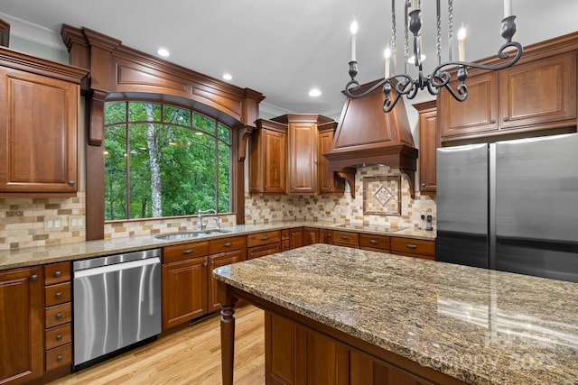 206 Stone Valley Way Unit 23, Hendersonville, NC 28792 - kitchen featuring stainless steel appliances, a sink, light wood-style flooring, light stone countertops, and decorative backsplash