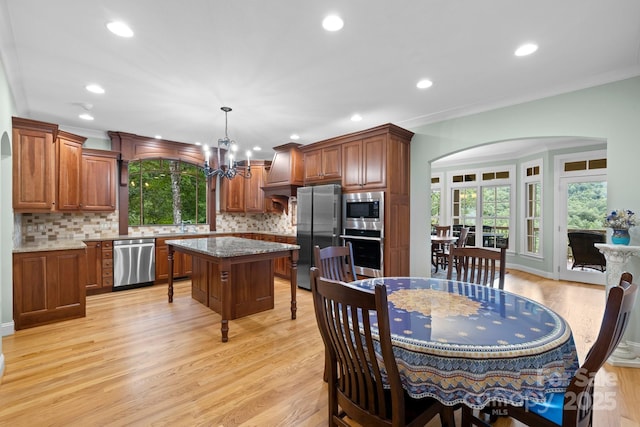 206 Stone Valley Way Unit 23, Hendersonville, NC 28792 - dining area with a chandelier, arched walkways, light wood finished floors, recessed lighting, and plenty of natural light