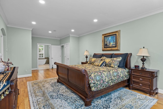 206 Stone Valley Way Unit 23, Hendersonville, NC 28792 - bedroom featuring crown molding, recessed lighting, baseboards, light wood-style floors, and arched walkways