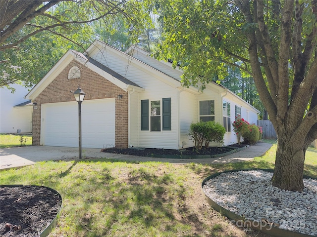 ranch-style home with brick siding, an attached garage, driveway, and a front yard