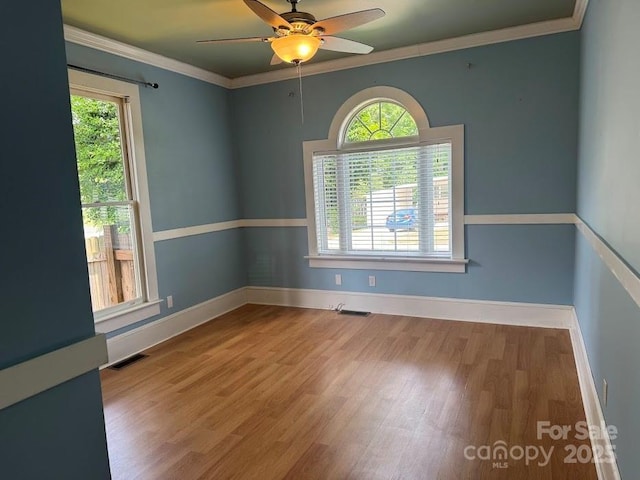 1019 Valley St, Kannapolis, NC 28081 - empty room featuring healthy amount of natural light, wood finished floors, ceiling fan, baseboards, and ornamental molding