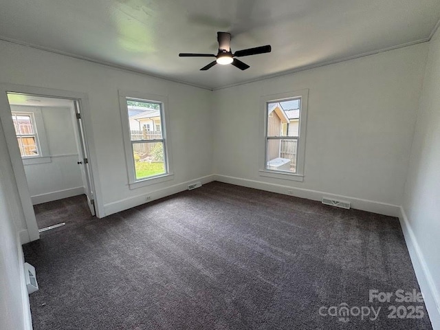 1019 Valley St, Kannapolis, NC 28081 - empty room featuring ceiling fan, dark colored carpet, baseboards, and crown molding