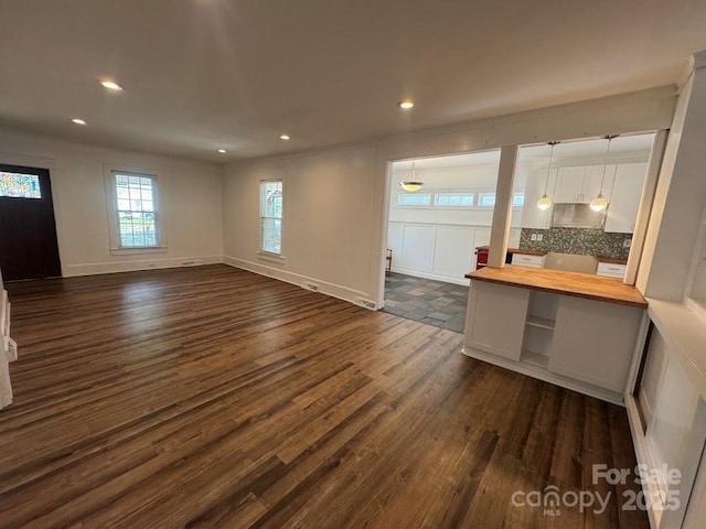 1019 Valley St, Kannapolis, NC 28081 - unfurnished living room with dark wood-type flooring, recessed lighting, and baseboards
