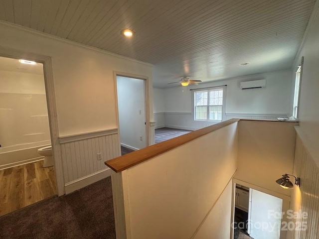 1019 Valley St, Kannapolis, NC 28081 - hallway featuring a wall unit AC, wainscoting, wood ceiling, ornamental molding, and dark carpet