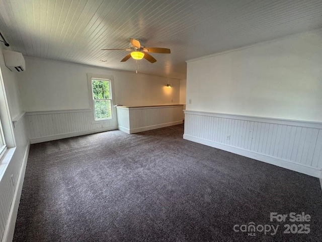 1019 Valley St, Kannapolis, NC 28081 - spare room featuring carpet floors, ceiling fan, wainscoting, and a wall mounted air conditioner