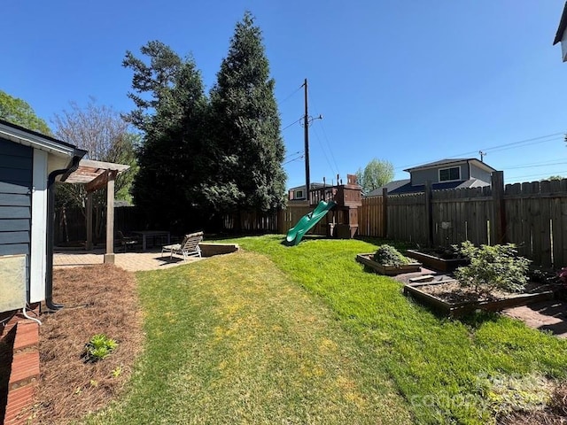 1019 Valley St, Kannapolis, NC 28081 - view of yard with a playground, a vegetable garden, and a patio
