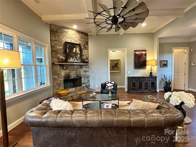 living area with ceiling fan, a fireplace, wood finished floors, baseboards, and ornamental molding
