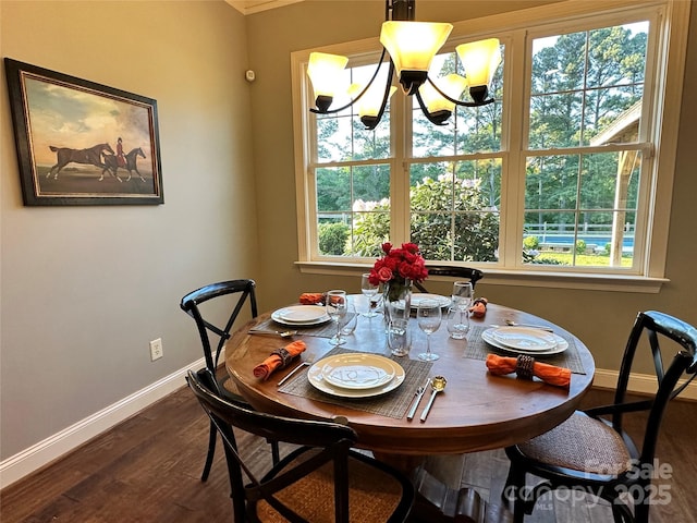 dining area featuring crown molding, baseboards, a chandelier, and dark wood-type flooring