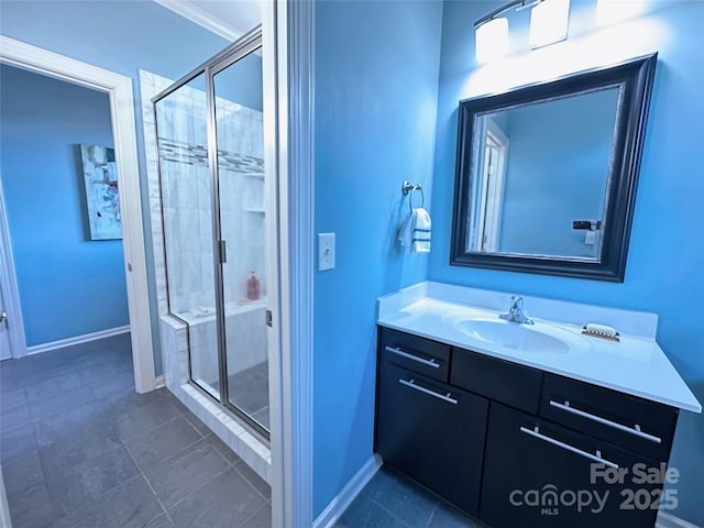 full bathroom with vanity, baseboards, tile patterned flooring, and a stall shower