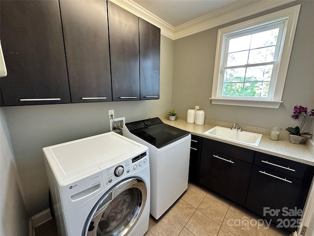 laundry area with crown molding, cabinet space, a sink, separate washer and dryer, and light tile patterned flooring