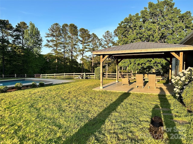 view of yard featuring a fenced backyard, a fenced in pool, a gazebo, and a patio area