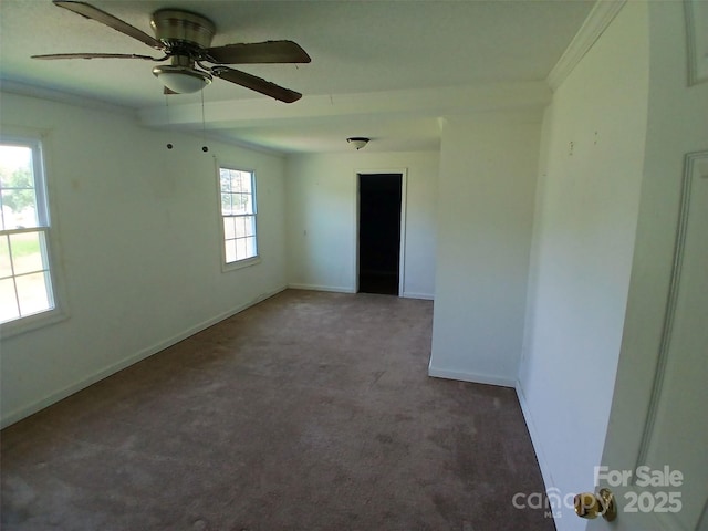 carpeted spare room featuring baseboards and ceiling fan
