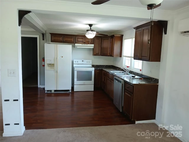 kitchen with dark countertops, white appliances, a ceiling fan, under cabinet range hood, and ornamental molding