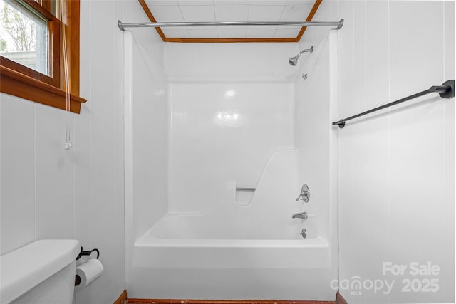 bathroom featuring toilet and tub / shower combination