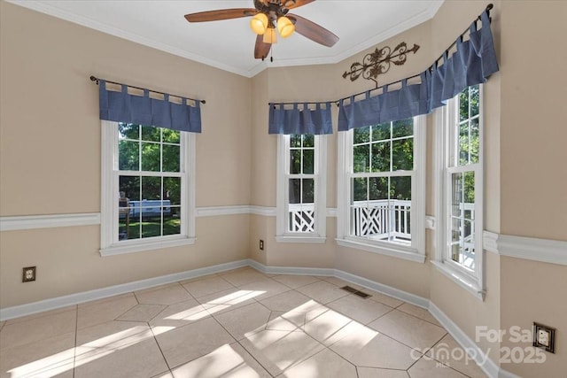 empty room with visible vents, a ceiling fan, a healthy amount of sunlight, and tile patterned flooring
