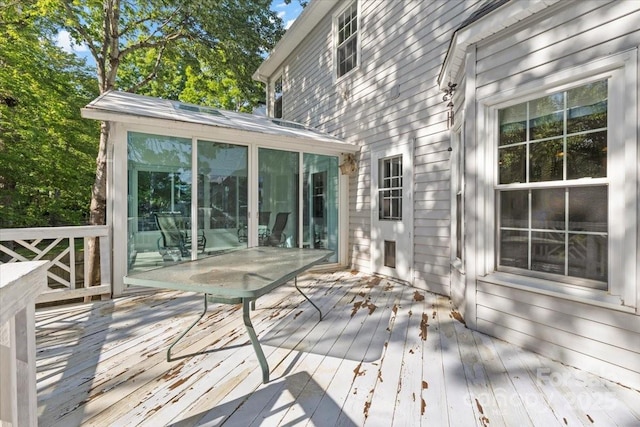 wooden deck featuring a sunroom