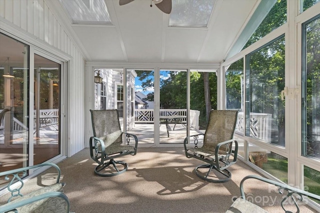 sunroom with ceiling fan, lofted ceiling, and carpet