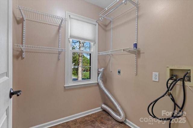 laundry area with hookup for an electric dryer, washer hookup, laundry area, and baseboards