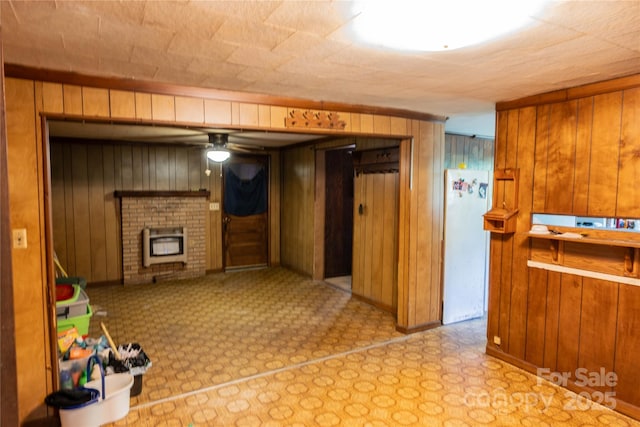 interior space featuring a ceiling fan and a fireplace