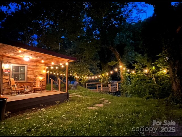yard at twilight with a deck