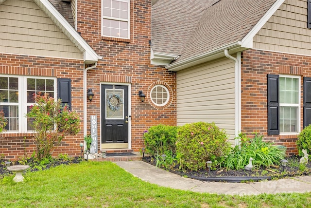 1835 Montague Rd, Clover, SC 29710 - view of exterior entry featuring brick siding, roof with shingles, and a yard